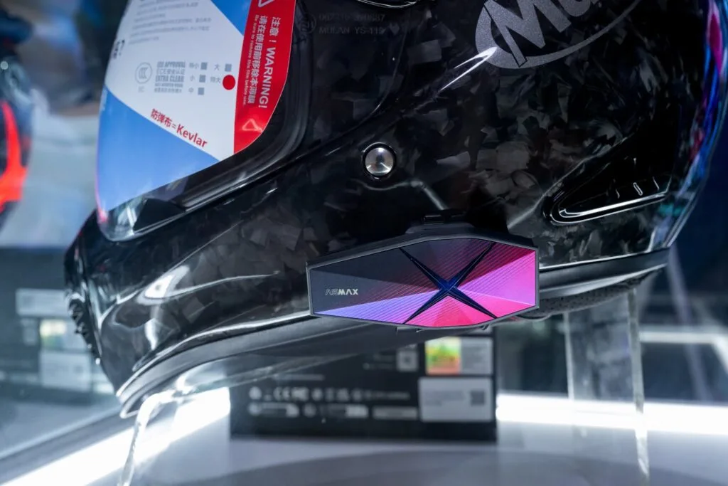 ASMAX RoamX motorcycle intercom mounted on a helmet at the CIMAMotor 2026 launch.