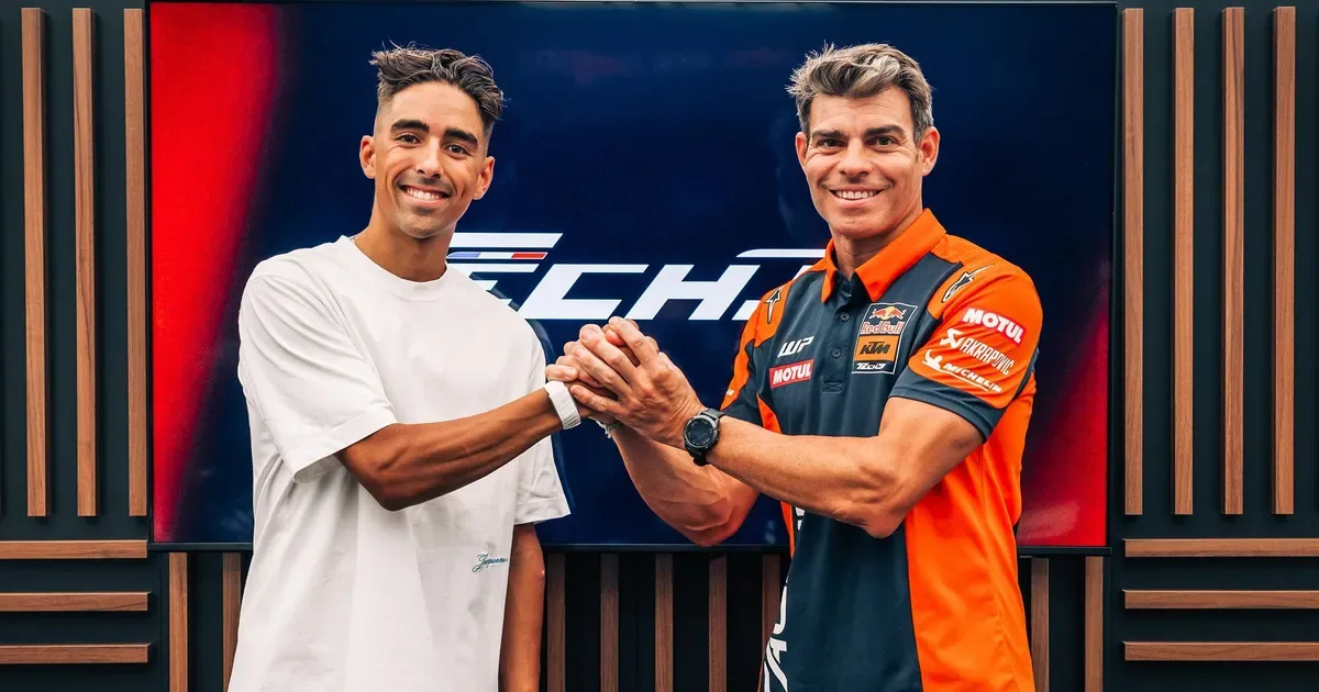 Senna Agius in Red Bull KTM Tech3 colours beside a MotoGP motorcycle