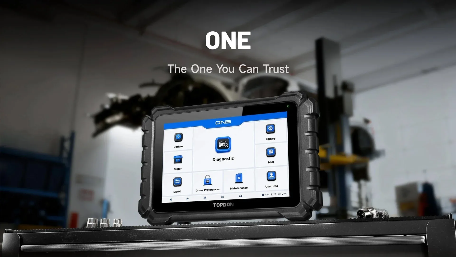 TOPDON ONE-series diagnostic tablet displayed in a professional workshop