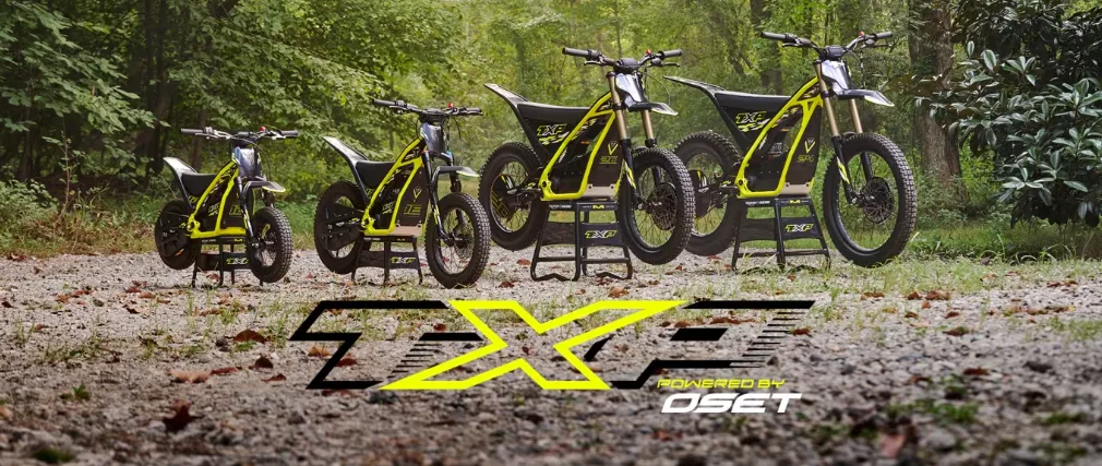 Triumph TXP-24 electric off-road motorcycle with riders on rocky terrain