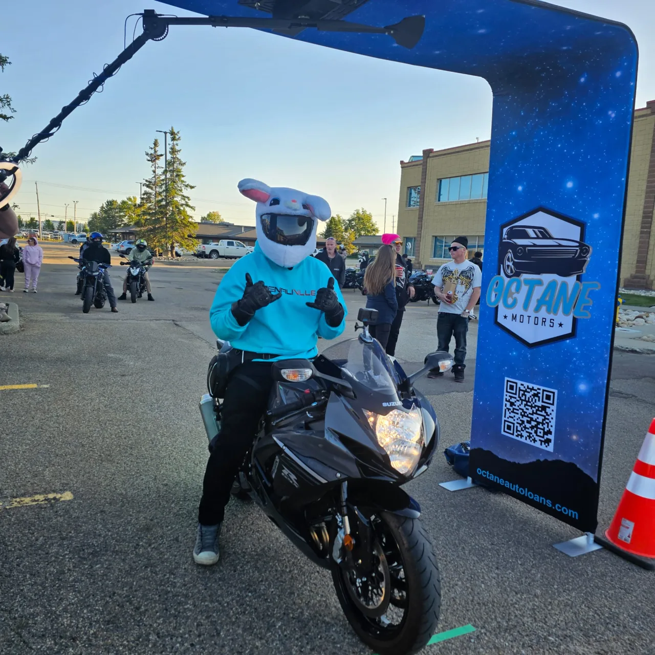 A rider sits on a Suzuki sport motorcycle beneath Octane Motors event branding during Full Throttle 360.