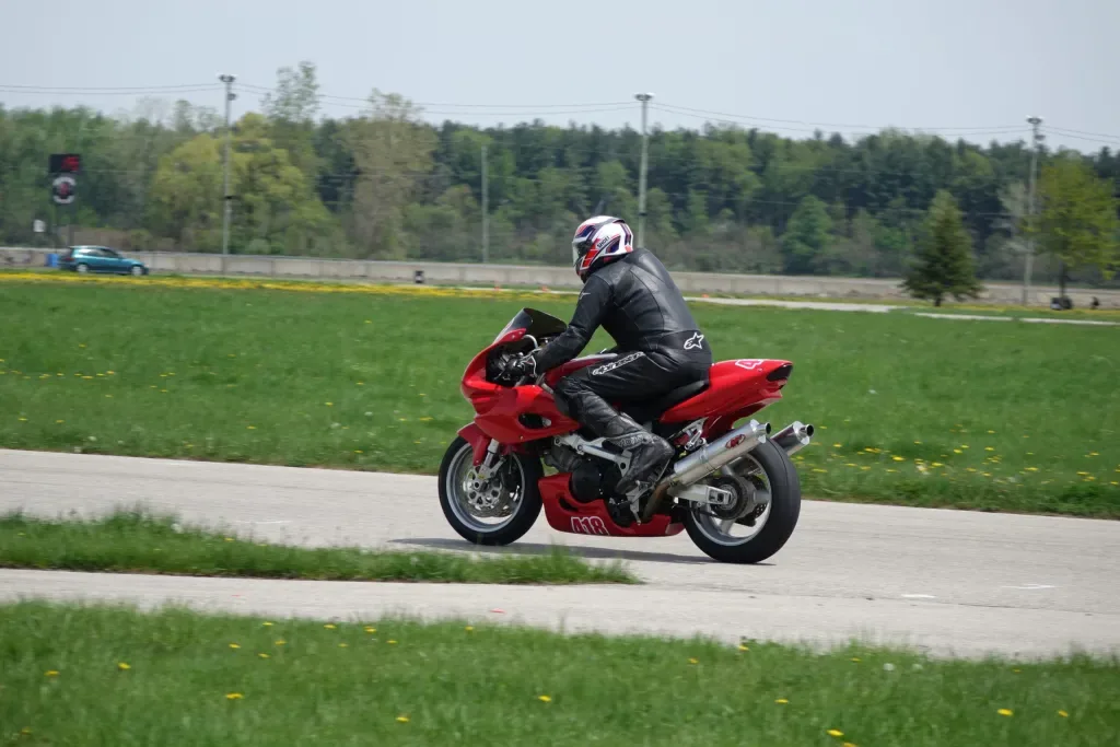 Motorcycle rider circulating on a road course during a KSR Track Days session.