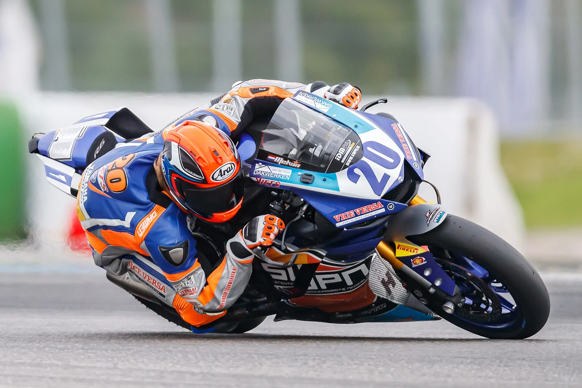 Road-racing motorcycles competing through a circuit corner