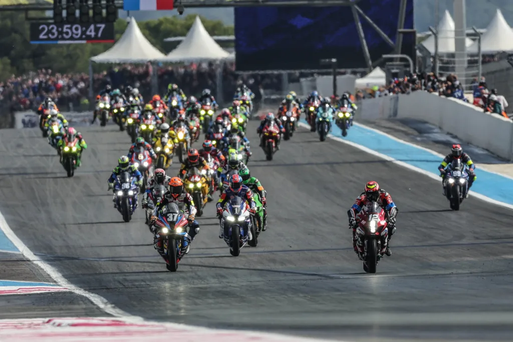 Motorcycle endurance field launching from the Bol d'Or starting grid at Circuit Paul Ricard.