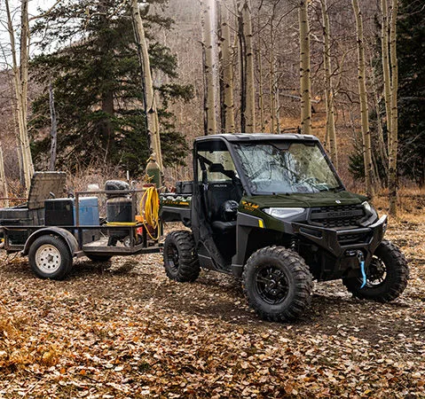 2027 Polaris RANGER XP 1000 side-by-side towing a utility trailer