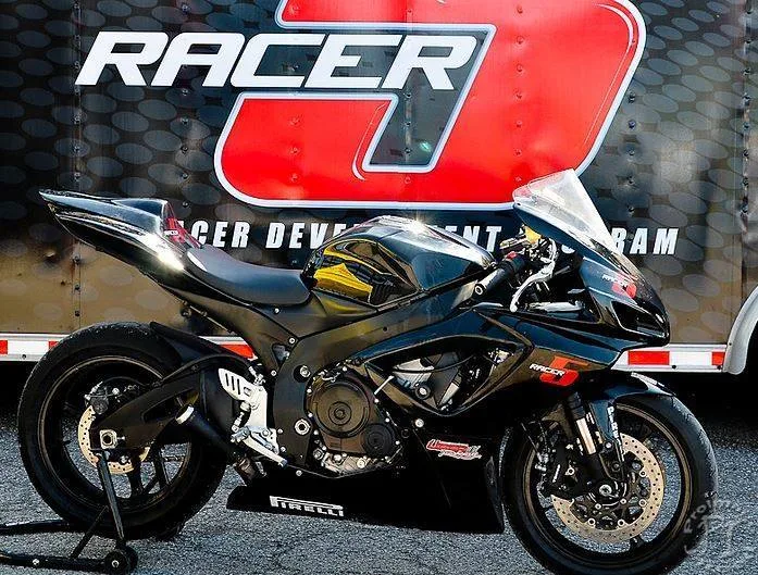 Motorcycle riders participating in a Racer5 closed-course track program.