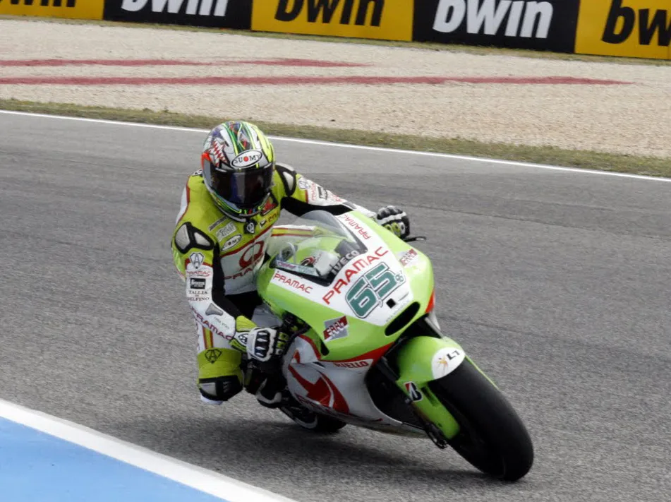 Loris Capirossi riding the Pramac Ducati MotoGP motorcycle at Estoril in 2011