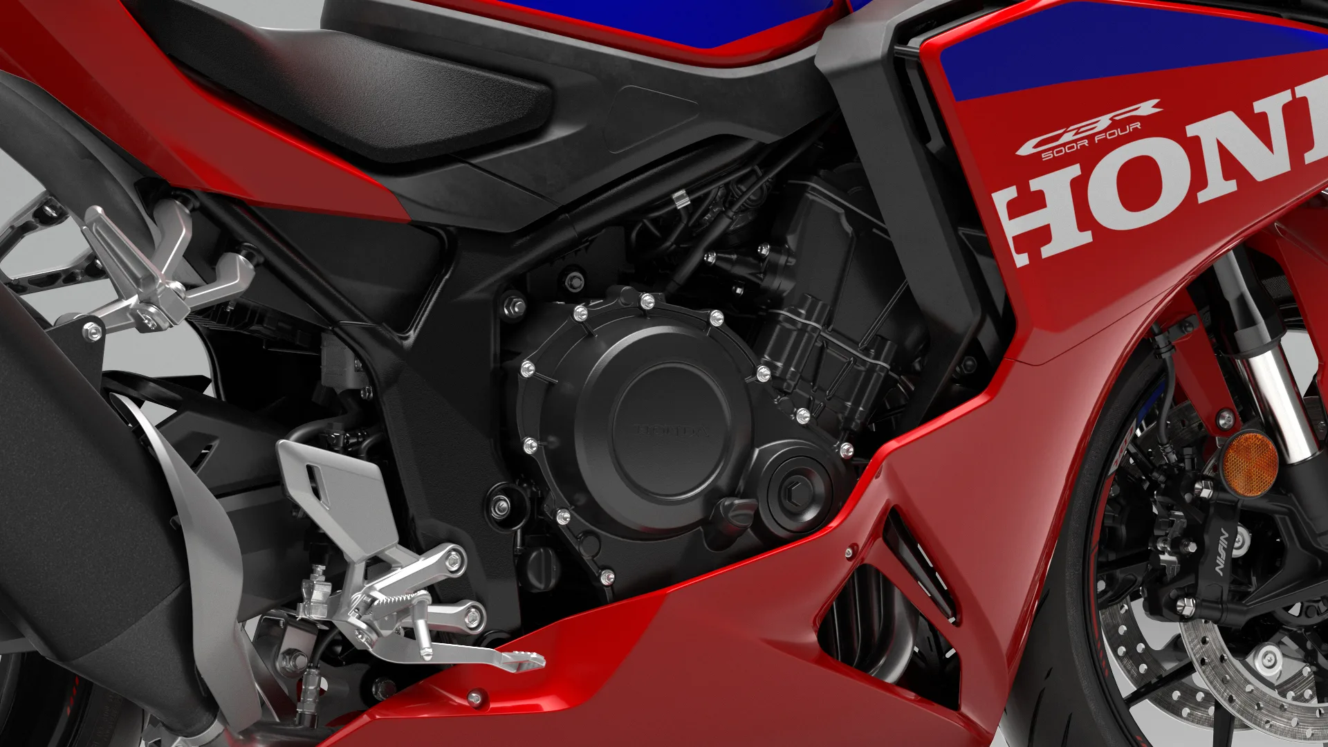 Close-up of the Honda CBR500R Four engine and E-Clutch hardware on the motorcycle’s right side