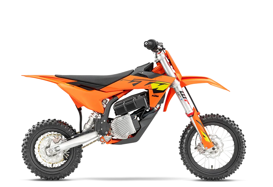 Studio side view of the orange KTM SX-E 5 electric youth motocross motorcycle
