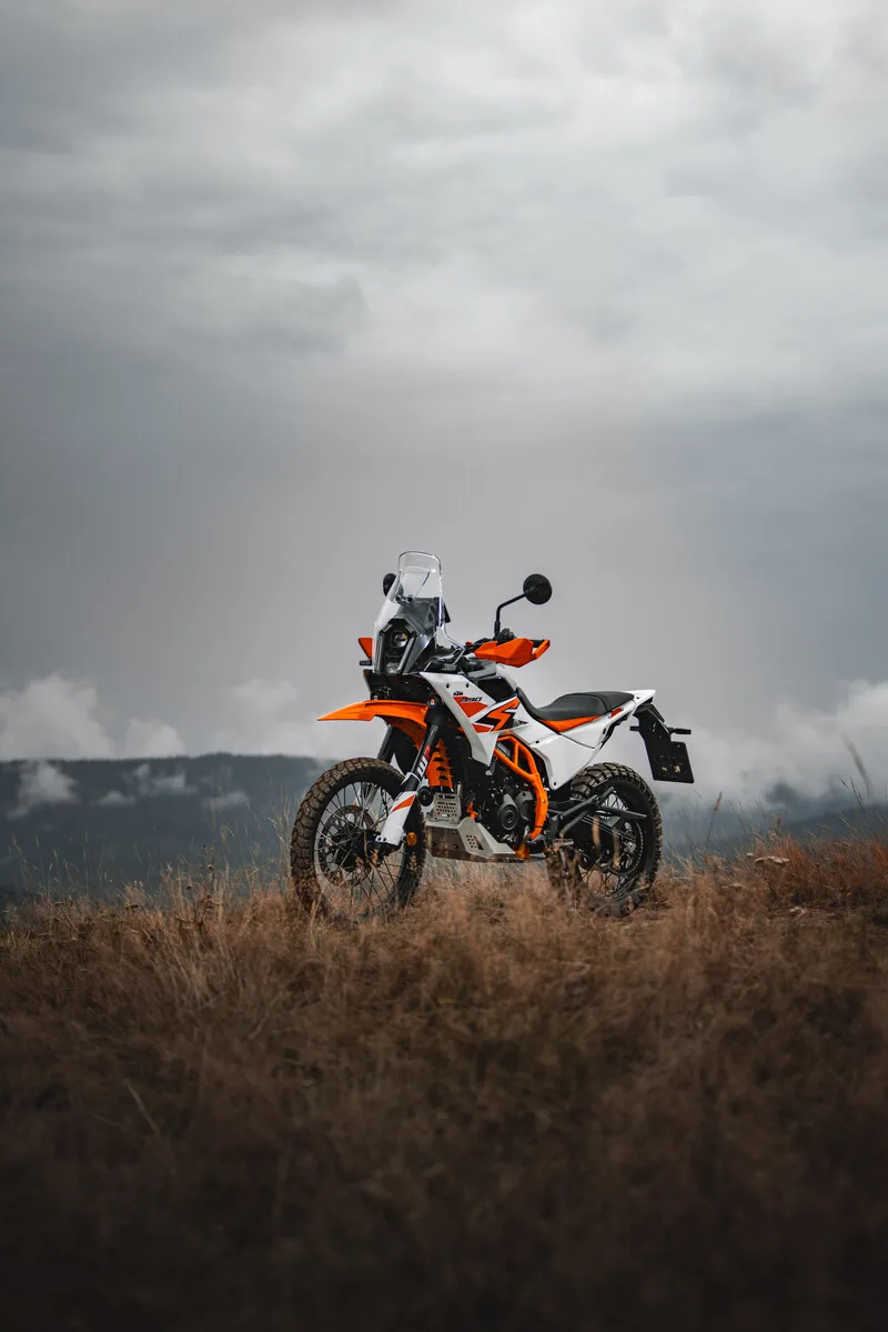 Side view of a 2025 KTM 390 Adventure R parked in open terrain.