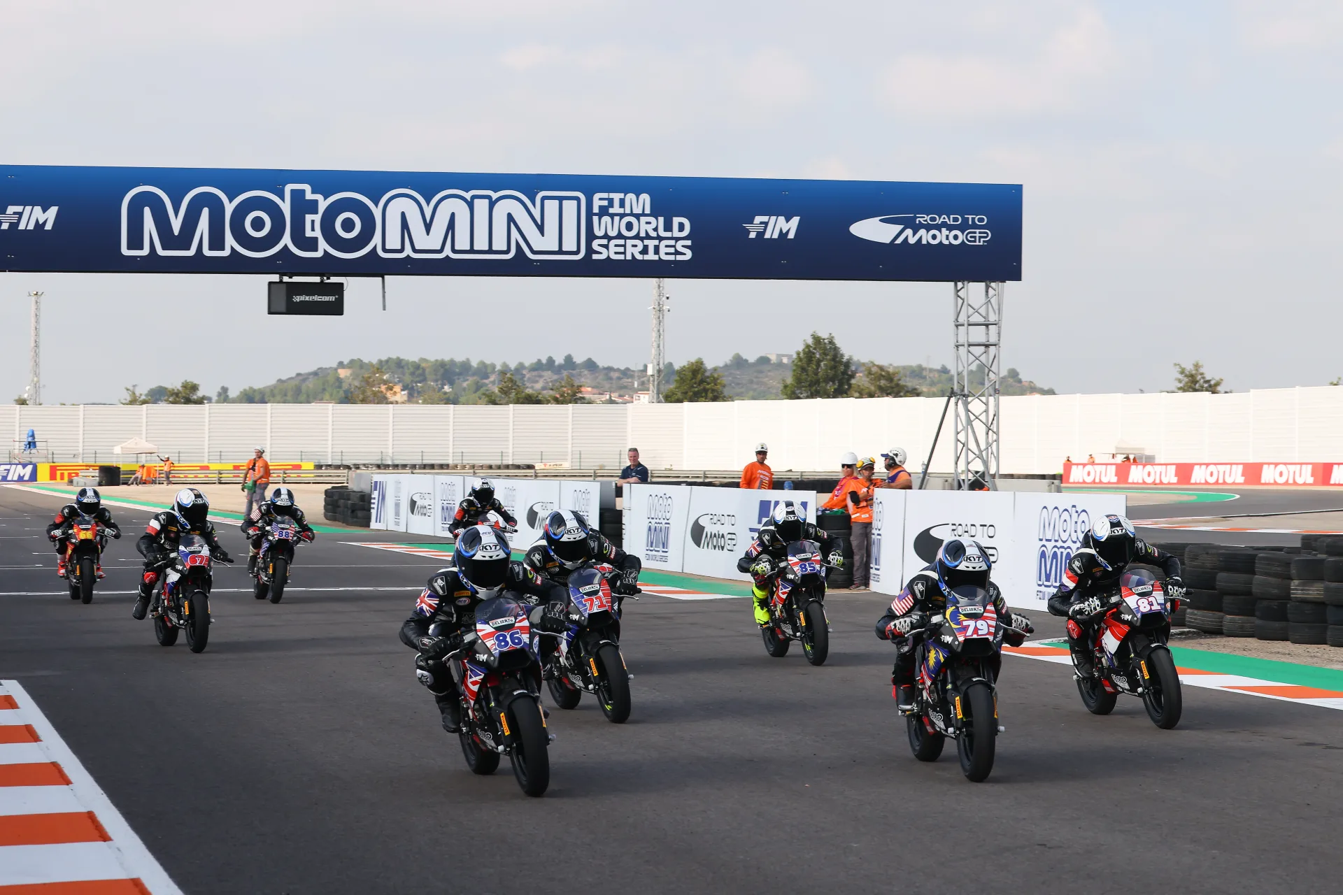 Young riders starting a FIM MotoMini World Series race under the Road to MotoGP pathway
