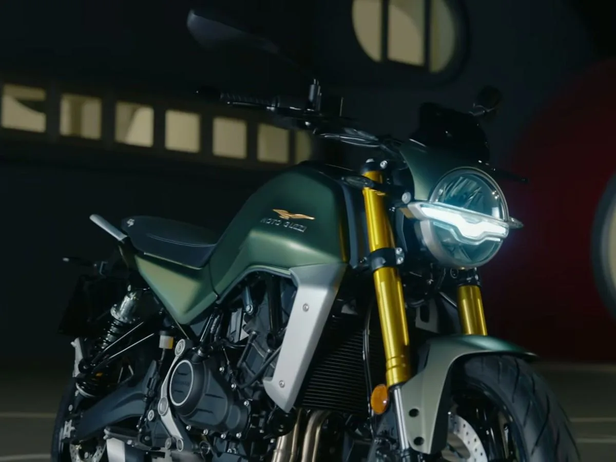 Moto Guzzi The Trip roadster parked in an urban setting.